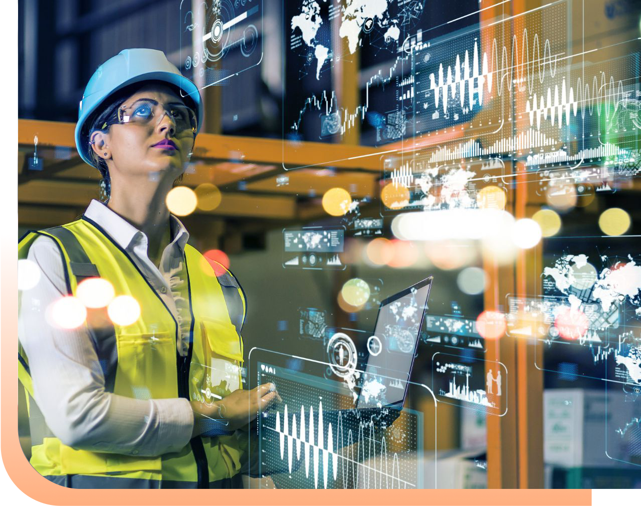 Female engineer in a hard hat and safety vest monitoring holographic data displays in a high-tech factory setting.
